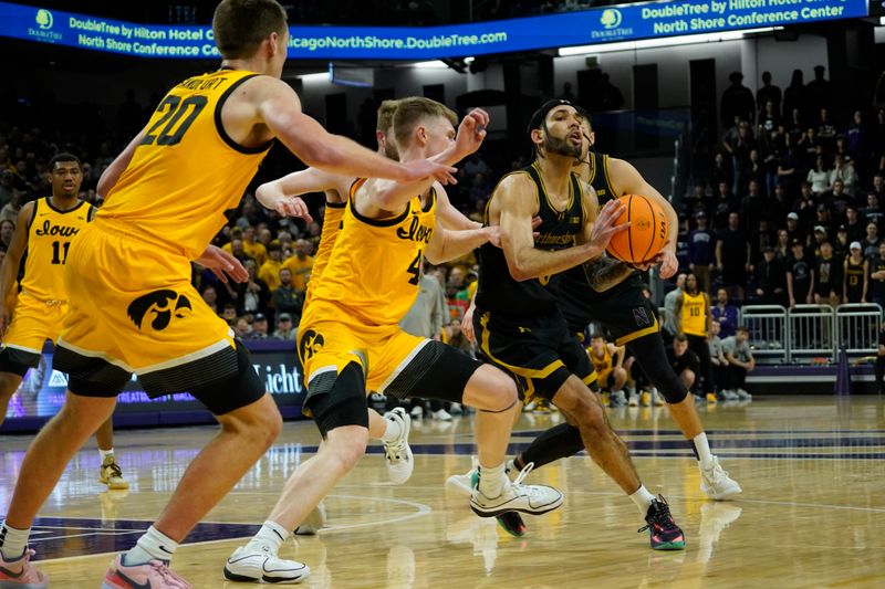 Mar 2, 2024; Evanston, Illinois, USA; Iowa Hawkeyes guard Josh Dix (4) defends Northwestern Wildcats guard Boo Buie (0) during the second half at Welsh-Ryan Arena. Mandatory Credit: David Banks-USA TODAY Sports