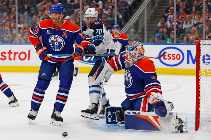 Sep 26, 2025; Edmonton, Alberta, CAN; /e. goaltender Calvin Pickard (30) makes a save while defensemen Darnell Nurse (25) and Winnipeg Jets forward Tanner Pearson (70) battle for position during the second period at Rogers Place. Mandatory Credit: Perry Nelson-Imagn Images