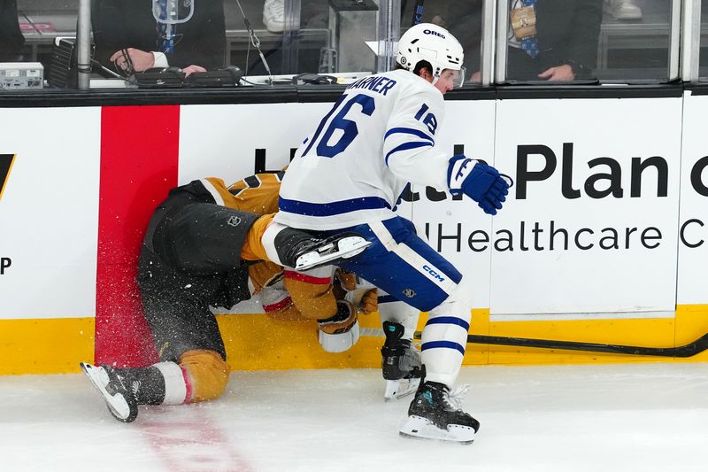 Mar 5, 2025; Las Vegas, Nevada, USA; Toronto Maple Leafs right wing Mitch Marner (16) checks Vegas Golden Knights right wing Victor Olofsson (95) during the third period at T-Mobile Arena. Mandatory Credit: Stephen R. Sylvanie-Imagn Images
