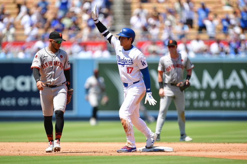 Jul 25, 2024; Los Angeles, California, USA; Los Angeles Dodgers designated hitter Shohei Ohtani (17) reaches second on a double against San Francisco Giants second baseman Thairo Estrada (39) during the fourth inning at Dodger Stadium. Mandatory Credit: Gary A. Vasquez-USA TODAY Sports