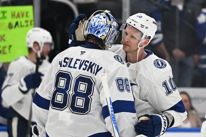 Mar 7, 2026; Toronto, Ontario, CAN;  Tampa Bay goalie Andrei Vasilevskiy (88) and forward Corey Perry (10) celebrate a win over the Toronto Maple Leafs at Scotiabank Arena. Mandatory Credit: Dan Hamilton-Imagn Images