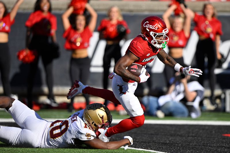 Sep 23, 2023; Louisville, Kentucky, USA;  Louisville Cardinals wide receiver Ahmari Huggins-Bruce (9) scores a touchdown despite the efforts of Boston College Eagles defensive back Jalen Cheek (10) during the second half at L&N Federal Credit Union Stadium. Louisville defeated Boston College 56-28. Mandatory Credit: Jamie Rhodes-USA TODAY Sports