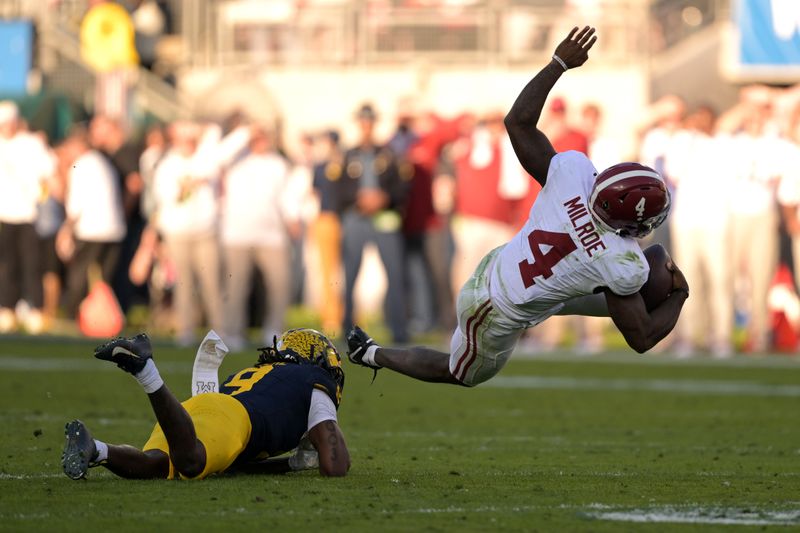 Jan 1, 2024; Pasadena, CA, USA; Alabama Crimson Tide quarterback Jalen Milroe (4) is tackled by Michigan Wolverines defensive back Rod Moore (9) during the first half in the 2024 Rose Bowl college football playoff semifinal game at Rose Bowl. Mandatory Credit: Jayne Kamin-Oncea-USA TODAY Sports