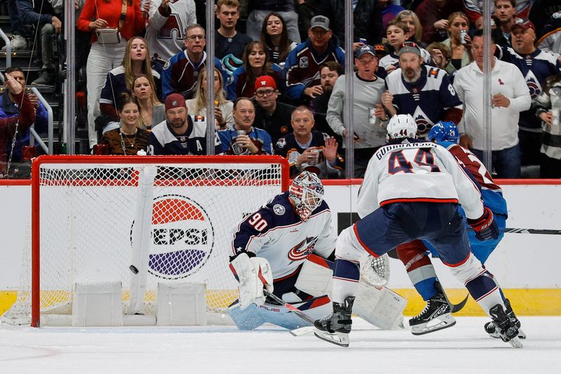 Mar 22, 2024; Denver, Colorado, USA; Colorado Avalanche center Nathan MacKinnon (29) scores a goal past Columbus Blue Jackets goaltender Elvis Merzlikins (90) as defenseman Erik Gudbranson (44) defends in the third period at Ball Arena. Mandatory Credit: Isaiah J. Downing-USA TODAY Sports