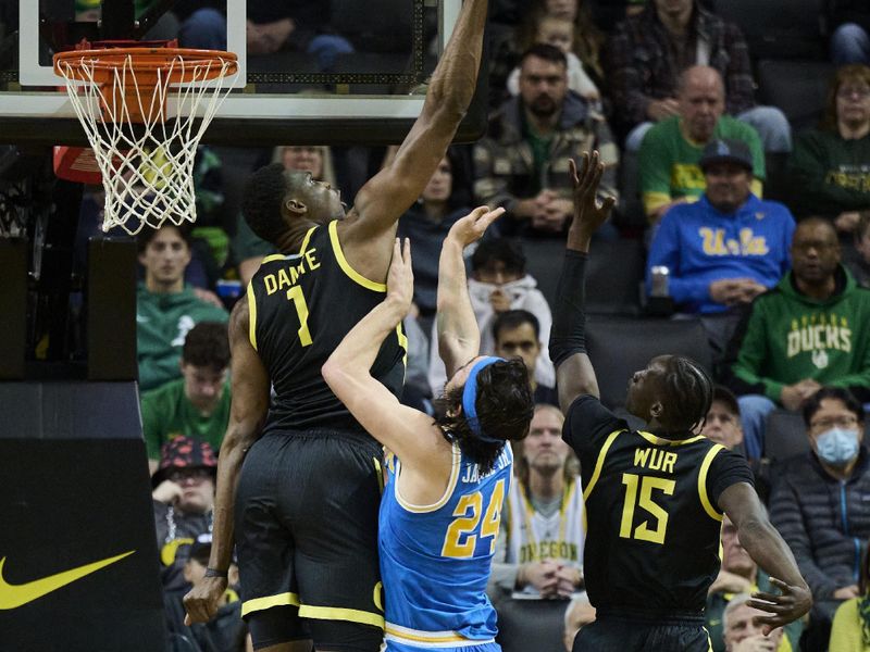 Feb 11, 2023; Eugene, Oregon, USA;  Oregon Ducks center N'Faly Dante (1) blocks a shot during the first half against UCLA Bruins guard Jaime Jaquez Jr. (24) at Matthew Knight Arena. Mandatory Credit: Troy Wayrynen-USA TODAY Sports