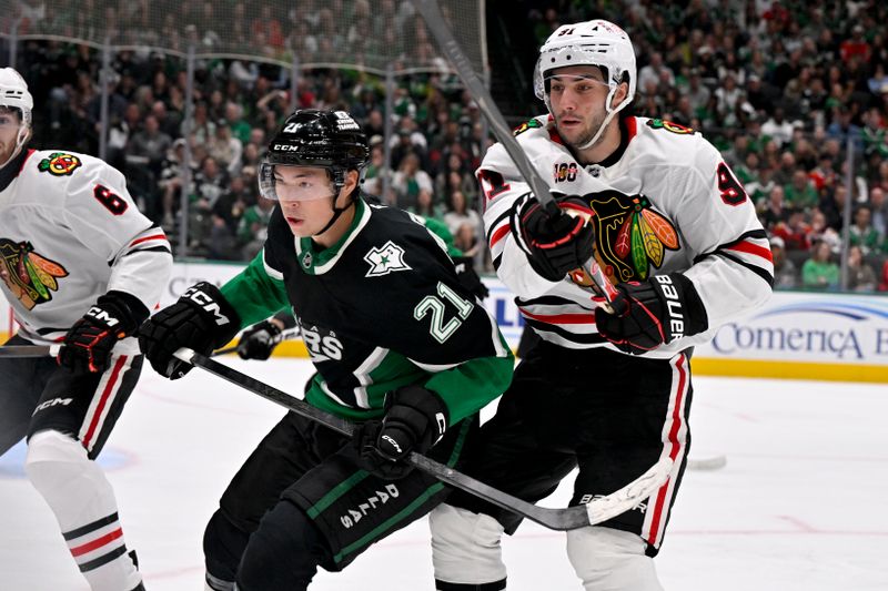 Mar 8, 2026; Dallas, Texas, USA; Dallas Stars left wing Jason Robertson (21) and Chicago Blackhawks center Frank Nazar (91) chase the puck during the second period at the American Airlines Center. Mandatory Credit: Jerome Miron-Imagn Images