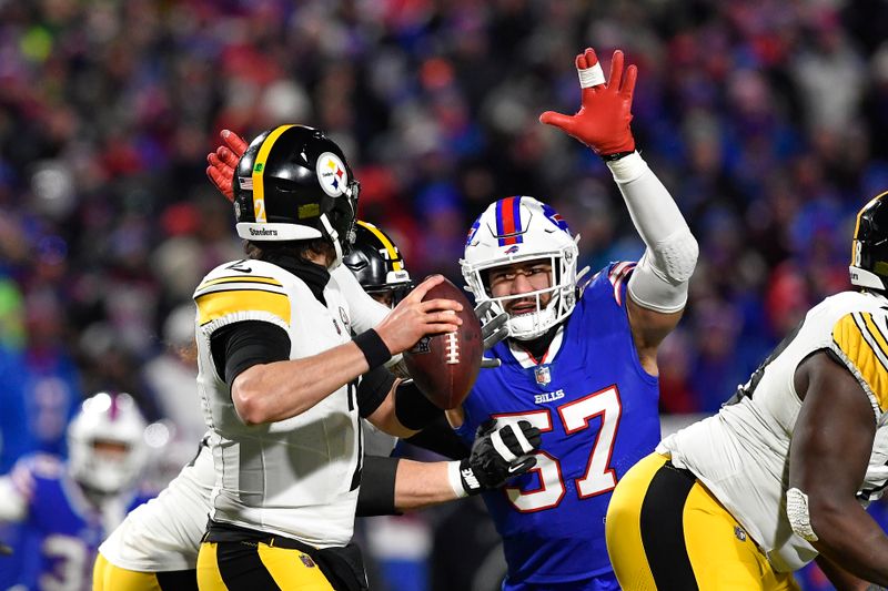 Buffalo Bills defensive end A.J. Epenesa (57) pressures Pittsburgh Steelers quarterback Mason Rudolph (2) during the second half of an NFL wild-card playoff football game in Orchard Park, N.Y., Monday, Jan. 15, 2024. (AP Photo/Adrian Kraus)