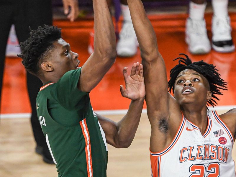 Feb 4, 2023; Clemson, South Carolina, USA; Miami forward Anthony Walker (1) shoots near Clemson forward RJ Godfrey (22) during the first half at Littlejohn Coliseum in Clemson, S.C. Saturday, Feb. 4, 2023.  Mandatory Credit: Ken Ruinard-USA TODAY Sports