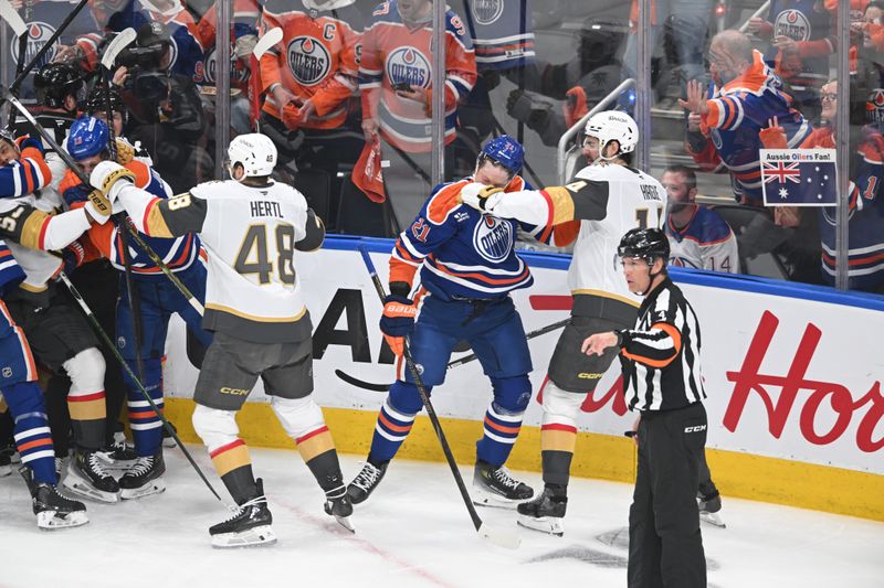 May 12, 2025; Edmonton, Alberta, CAN; Edmonton Oilers center Trent Frederic (21) fights with Vegas Golden Knights defenceman Nicolas Hague (14) during the first period in game three of the second round of the 2025 Stanley Cup Playoffs at Rogers Place. Mandatory Credit: Walter Tychnowicz-Imagn Images