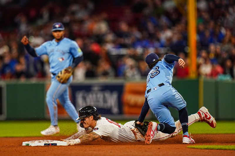 Aug 29, 2024; Boston, Massachusetts, USA; Boston Red Sox center fielder Jarren Duran (16) tagged out by Toronto Blue Jays shortstop Ernie Clement (28) in the fourth inning at Fenway Park. Mandatory Credit: David Butler II-USA TODAY Sports