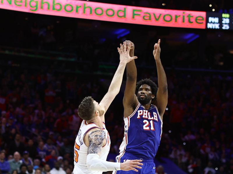 PHILADELPHIA, PENNSYLVANIA - APRIL 25: Joel Embiid #21 of the Philadelphia 76ers shoots over Isaiah Hartenstein #55 of the New York Knicks during the third quarter of game three of the Eastern Conference First Round Playoffs at the Wells Fargo Center on April 25, 2024 in Philadelphia, Pennsylvania. NOTE TO USER: User expressly acknowledges and agrees that, by downloading and/or using this Photograph, user is consenting to the terms and conditions of the Getty Images License Agreement. (Photo by Tim Nwachukwu/Getty Images)