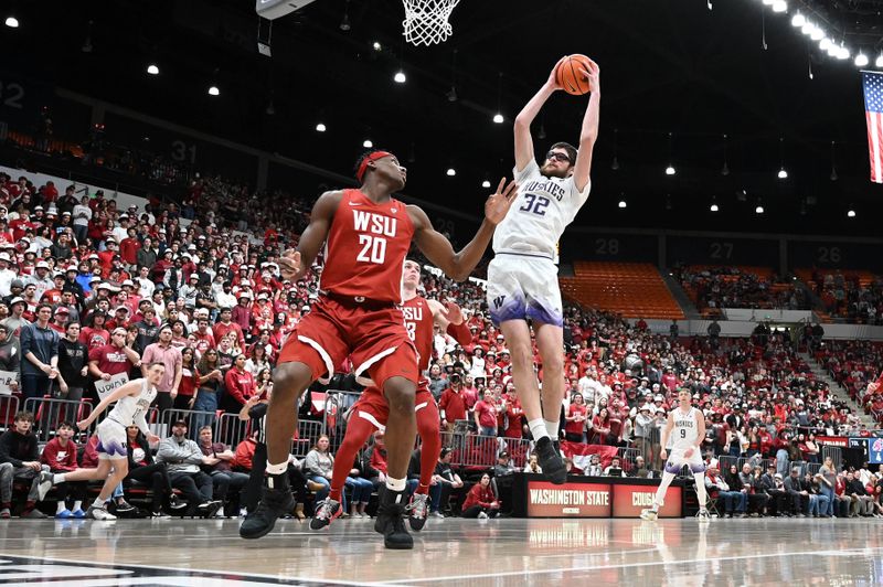 Mar 7, 2024; Pullman, Washington, USA; Washington Huskies forward Wilhelm Breidenbach (32) rebounds the ball against Washington State Cougars center Rueben Chinyelu (20) in the first half at Friel Court at Beasley Coliseum. Mandatory Credit: James Snook-USA TODAY Sports