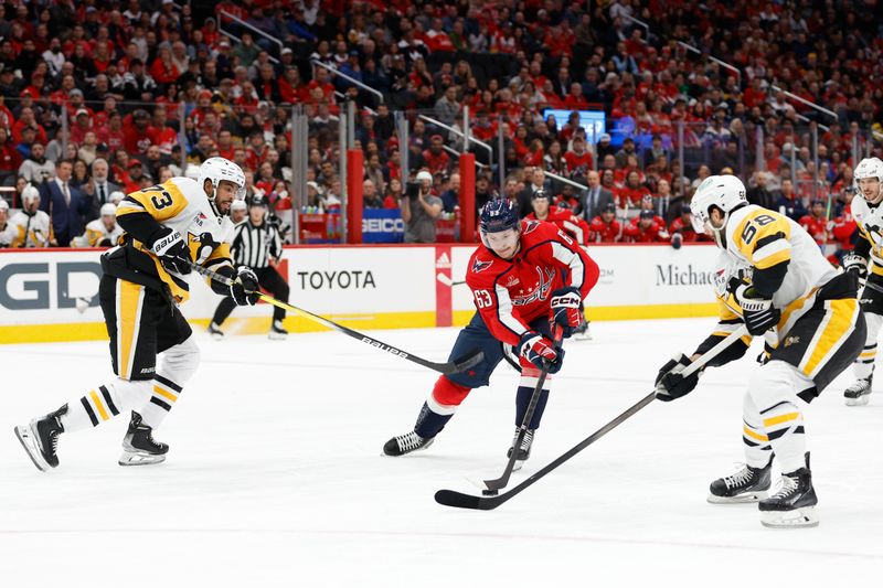 Apr 4, 2024; Washington, District of Columbia, USA; Washington Capitals left wing Ivan Miroshnichenko (63) skates with the puck as Pittsburgh Penguins defenseman Pierre-Olivier Joseph (73) and Pittsburgh Penguins defenseman Ryan Shea (5) defend in the first period at Capital One Arena. Mandatory Credit: Geoff Burke-USA TODAY Sports