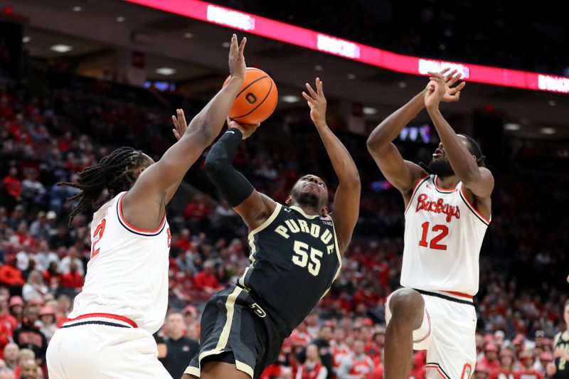 Feb 18, 2024; Columbus, Ohio, USA;  Purdue Boilermakers guard Lance Jones (55) shoots the ball as Ohio State Buckeyes guard Evan Mahaffey (12) and guard Bruce Thornton (2) defends during the first half at Value City Arena. Mandatory Credit: Joseph Maiorana-USA TODAY Sports