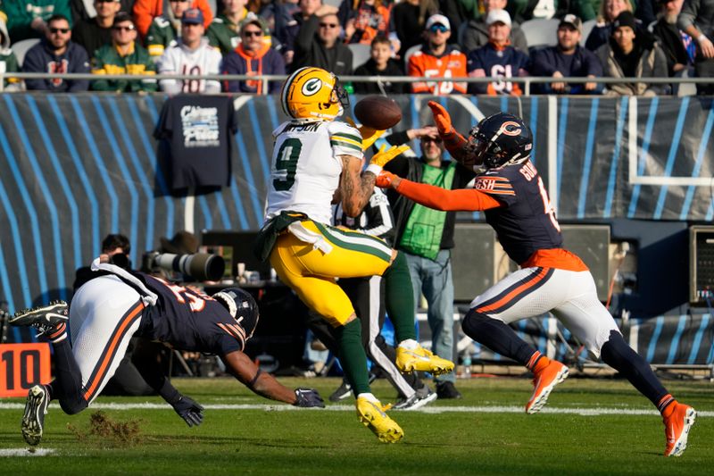 Green Bay Packers' Christian Watson catches a pass between two defenders during the second half of an NFL football game against the Chicago Bears Sunday, Nov. 17, 2024, in Chicago. (AP Photo/Nam Y. Huh)