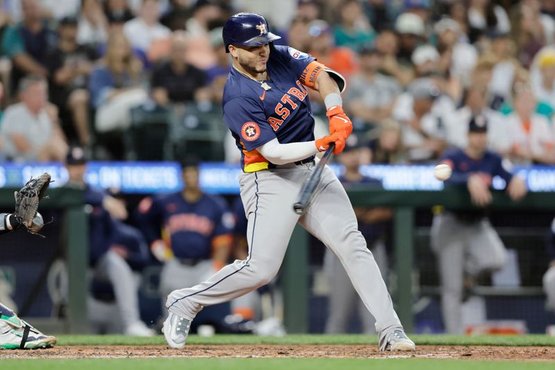 Jul 20, 2024; Seattle, Washington, USA; Houston Astros catcher Yainer Diaz (21) hits a solo home run against the Seattle Mariners during the eighth inning at T-Mobile Park. Mandatory Credit: John Froschauer-USA TODAY Sports