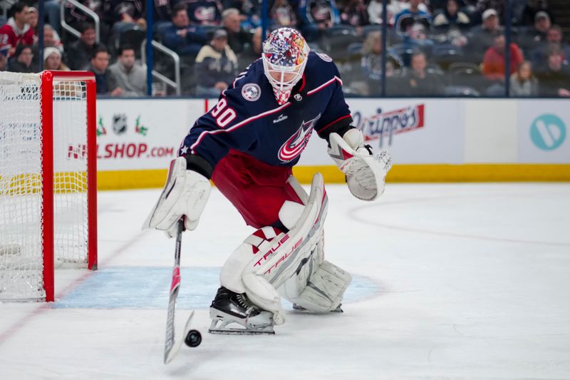 Nov 29, 2023; Columbus, Ohio, USA;  Columbus Blue Jackets goaltender Elvis Merzlikins (90) controls the puck against the Montreal Canadiens in the third period at Nationwide Arena. Mandatory Credit: Aaron Doster-USA TODAY Sports