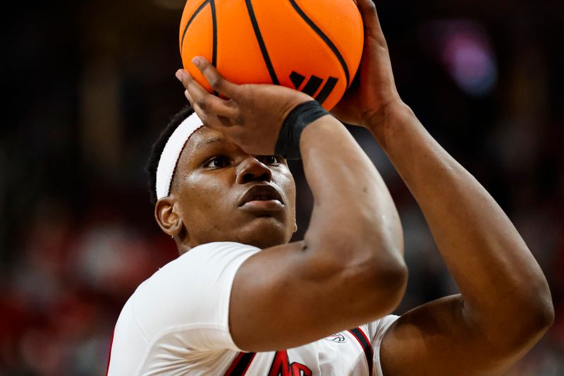 Dec 6, 2025; Raleigh, North Carolina, USA; NC State Wolfpack forward Ven-Allen Lubin (22) shoots a free throw during the second half of the game against the Liberty Flames at Lenovo Center. Mandatory Credit: Jaylynn Nash-Imagn Images
