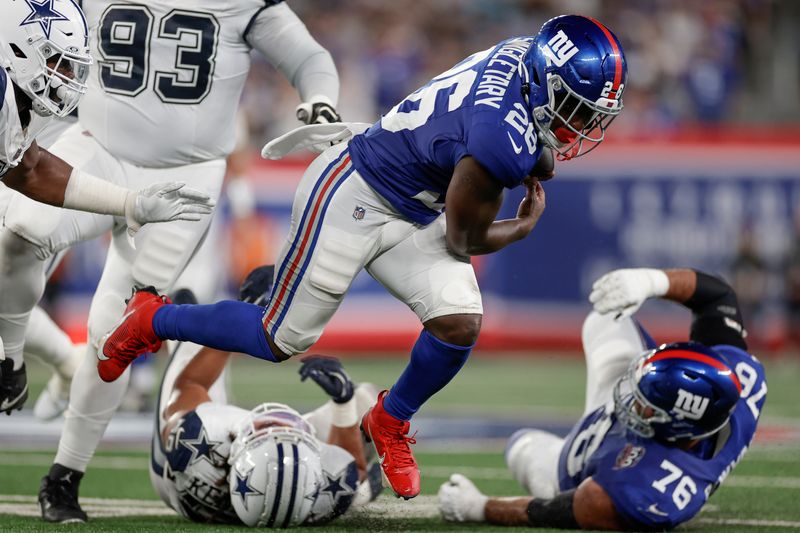 New York Giants running back Devin Singletary (26) carries the ball against the Dallas Cowboys during the second quarter of an NFL football game, Thursday, Sept. 26, 2024, in East Rutherford, N.J. (AP Photo/Adam Hunger)