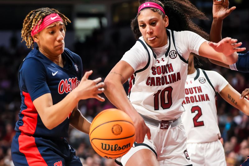 Feb 4, 2024; Columbia, South Carolina, USA; Ole Miss Rebels guard Kennedy Todd-Williams (3) and South Carolina Gamecocks center Kamilla Cardoso (10) battle for the ball in the second half at Colonial Life Arena. Mandatory Credit: Jeff Blake-USA TODAY Sports