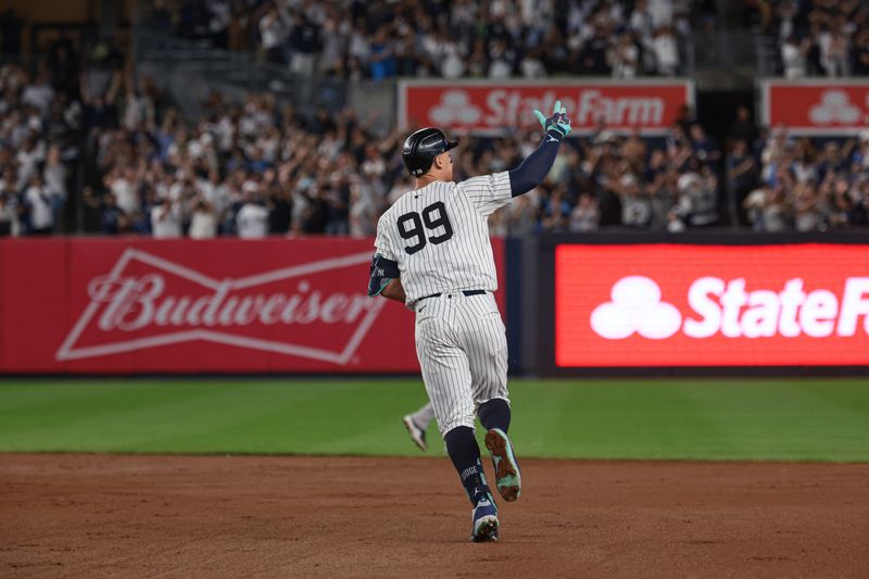 Sep 13, 2024; Bronx, New York, USA; New York Yankees center fielder Aaron Judge (99) celebrates while running the bases after hitting a grand slam home run during the seventh inning against the Boston Red Sox at Yankee Stadium. Mandatory Credit: Vincent Carchietta-Imagn Images