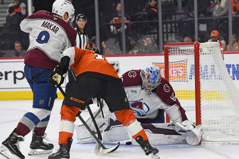 Nov 18, 2024; Philadelphia, Pennsylvania, USA; Colorado Avalanche goaltender Justus Annunen (60) and Colorado Avalanche defenseman Cale Makar (8) battle for the puck with Philadelphia Flyers right wing Bobby Brink (10) during the third period at Wells Fargo Center. Mandatory Credit: Eric Hartline-Imagn Images