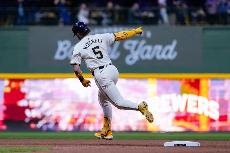 Sep 19, 2024; Milwaukee, Wisconsin, USA;  Milwaukee Brewers designated hitter Garrett Mitchell (5) celebrates after hitting a home run during the seventh inning against the Arizona Diamondbacks at American Family Field. Mandatory Credit: Jeff Hanisch-Imagn Images