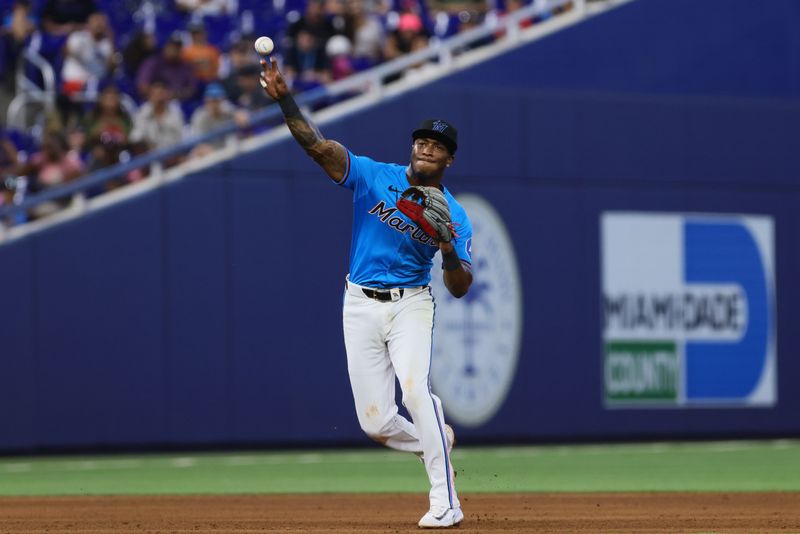 Jun 2, 2024; Miami, Florida, USA; Miami Marlins shortstop Tim Anderson (7) throws to first base to against the Texas Rangers during the eighth inning at loanDepot Park. Mandatory Credit: Sam Navarro-USA TODAY Sports