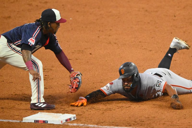 Jul 5, 2024; Cleveland, Ohio, USA; San Francisco Giants center fielder Heliot Ramos (17) is tagged out by Cleveland Guardians third baseman Jose Ramirez (11) in the fifth inning at Progressive Field. Mandatory Credit: David Richard-USA TODAY Sports