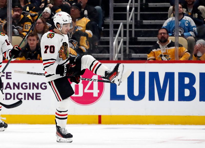 Oct 10, 2023; Pittsburgh, Pennsylvania, USA; Chicago Blackhawks center Cole Guttman (70) reacts after scoring the game winning goal against the Pittsburgh Penguins during the third period at the PPG Paints Arena. Chicago won 4-2.  Mandatory Credit: Charles LeClaire-USA TODAY Sports