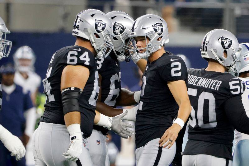 Las Vegas Raiders guard Alex Bars (64) and place kicker Daniel Carlson (2) celebrate after Carlson kicked a 50-yard field goal in the second half of a preseason NFL football game against the Dallas Cowboys in Arlington, Texas, Saturday, Aug. 26, 2023. (AP Photo/Michael Ainsworth)