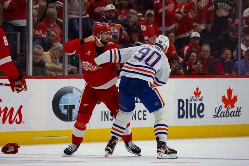 Oct 27, 2024; Detroit, Michigan, USA; Detroit Red Wings center Joe Veleno (90) fights with Edmonton Oilers right wing Corey Perry (90) during the first period of the game at Little Caesars Arena. Mandatory Credit: Brian Bradshaw Sevald-Imagn Images