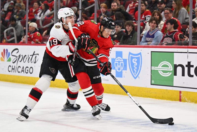 Mar 6, 2023; Chicago, Illinois, USA;  Ottawa Senators forward Drake Batherson (19) checks Chicago Blackhawks defenseman Caleb Jones (82) in the first period at United Center. Mandatory Credit: Jamie Sabau-USA TODAY Sports