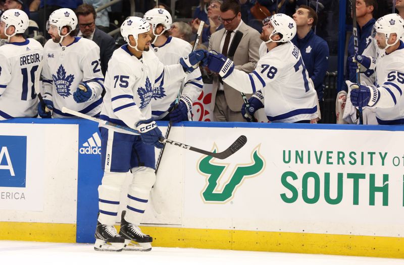 Apr 17, 2024; Tampa, Florida, USA; Toronto Maple Leafs right wing Ryan Reaves (75) is congratulated by defenseman TJ Brodie (78) and teammates against the Tampa Bay Lightning during the first period at Amalie Arena. Mandatory Credit: Kim Klement Neitzel-USA TODAY Sports