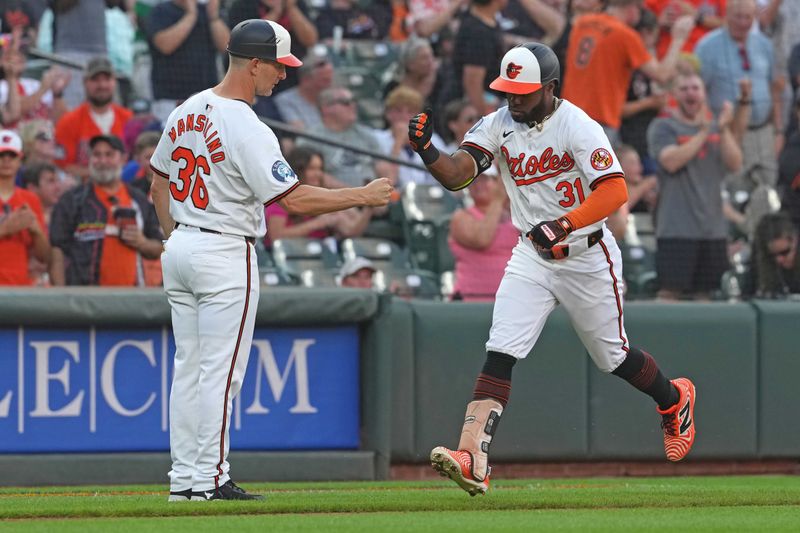 Jun 27, 2024; Baltimore, Maryland, USA; Baltimore Orioles outfielder Cedric Mullins (31) greeted by coach Tony Mansolino (36) following his two-run home run in the fourth inning against the Texas Rangers at Oriole Park at Camden Yards. Mandatory Credit: Mitch Stringer-USA TODAY Sports