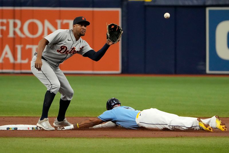 Apr 2, 2023; St. Petersburg, Florida, USA; Tampa Bay Rays shortstop Wander Franco (5) steals second base as Detroit Tigers second baseman Jonathan Schoop (7) tries to make the tag during the first inning at Tropicana Field. Mandatory Credit: Dave Nelson-USA TODAY Sports