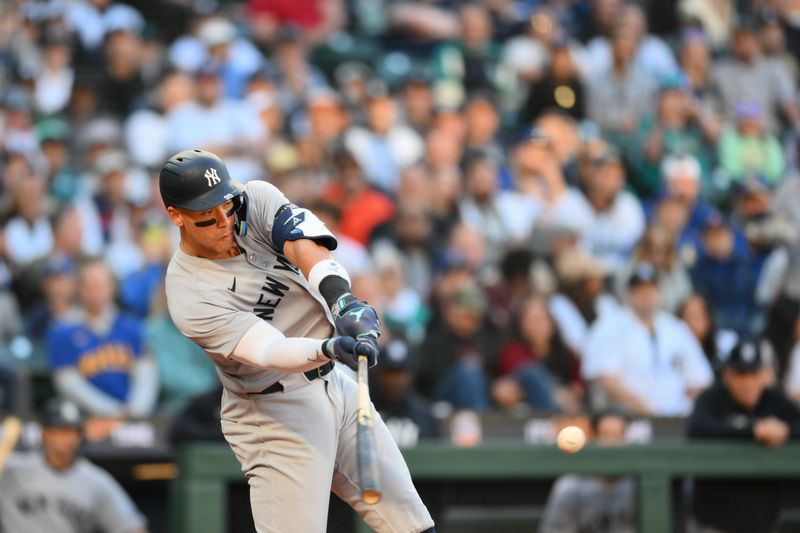 May 12, 2025; Seattle, Washington, USA; New York Yankees right fielder Aaron Judge (99) hits a double against the Seattle Mariners during the third inning at T-Mobile Park. Mandatory Credit: Steven Bisig-Imagn Images