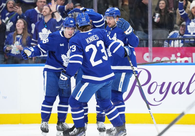 Feb 17, 2024; Toronto, Ontario, CAN; Toronto Maple Leafs center Auston Matthews (34) scores a goal and celebrates with right wing Mitchell Marner (16) against the Anaheim Ducks during the first period at Scotiabank Arena. Mandatory Credit: Nick Turchiaro-USA TODAY Sports