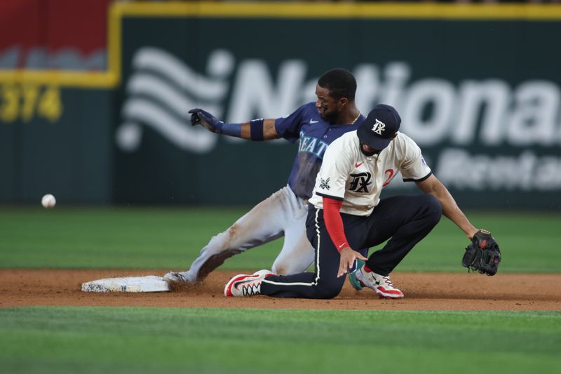 Sep 20, 2024; Arlington, Texas, USA; Seattle Mariners right fielder Victor Robles (10) steals second base against Texas Rangers second baseman Marcus Semien (2) in the third inning at Globe Life Field. Mandatory Credit: Tim Heitman-Imagn Images