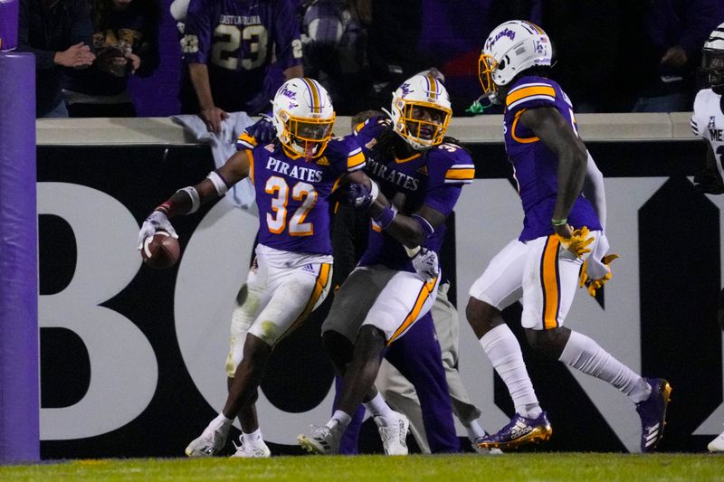 Oct 15, 2022; Greenville, North Carolina, USA;  East Carolina Pirates safety Julius Wood (32) scores a touchdown on his interception return against the Memphis Tigers during the second half at Dowdy-Ficklen Stadium. Mandatory Credit: James Guillory-USA TODAY Sports