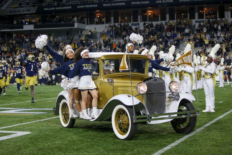 Oct 20, 2022; Atlanta, Georgia, USA; Georgia Tech Yellow Jackets cheerleaders ride the Ramblin' Wreck car onto the field before a game against the Virginia Cavaliers at Bobby Dodd Stadium. Mandatory Credit: Brett Davis-USA TODAY Sports
