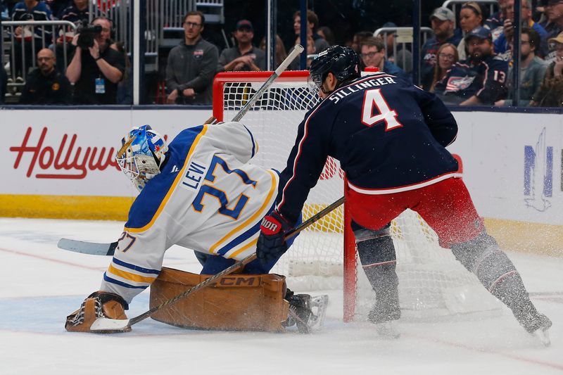 Oct 17, 2024; Columbus, Ohio, USA; Buffalo Sabres goalie Devon Levi (27) covers the loose puck as Columbus Blue Jackets center Cole Sillinger (4) looks for a rebound during the second period at Nationwide Arena. Mandatory Credit: Russell LaBounty-Imagn Images