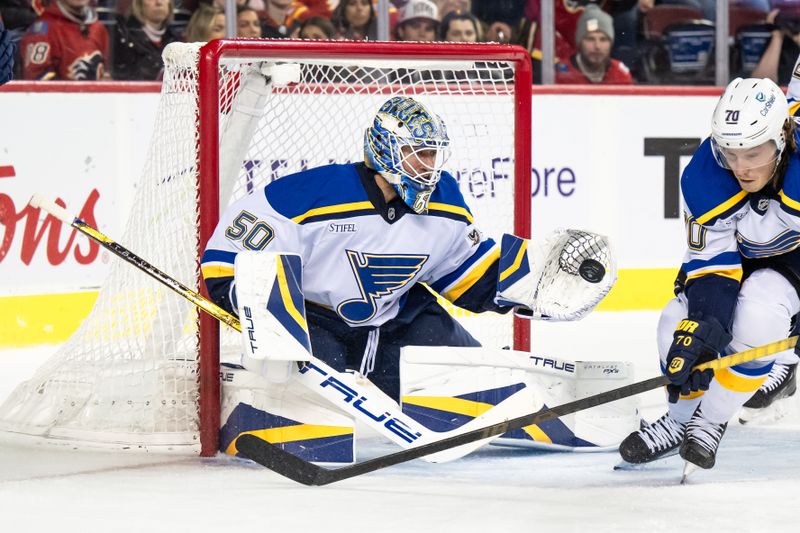 Dec 5, 2024; Calgary, Alberta, CAN; St. Louis Blues goaltender Jordan Binnington (50) makes a save against the Calgary Flames during the second period at Scotiabank Saddledome. Mandatory Credit: Brett Holmes-Imagn Images