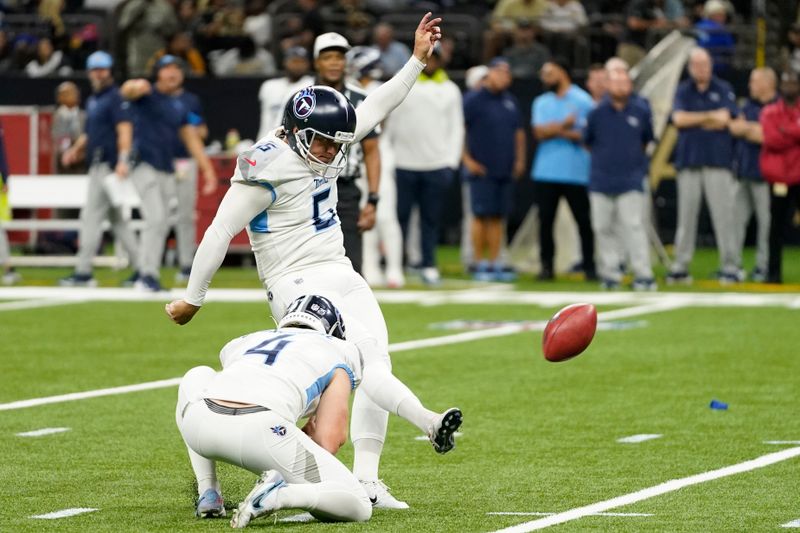 Tennessee Titans place-kicker Nick Folk kicks a 31-yard field goal as punter Ryan Stonehouse (4) holds against the New Orleans Saints in the first half of an NFL football game in New Orleans, Sunday, Sept. 10, 2023. (AP Photo/Gerald Herbert)