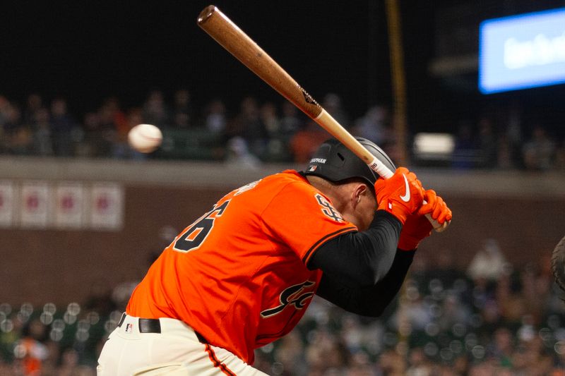 Aug 9, 2024; San Francisco, California, USA; San Francisco Giants third baseman Matt Chapman (26) is hit by a pitch from Detroit Tigers pitcher Jason Foley during the ninth inning at Oracle Park. Mandatory Credit: D. Ross Cameron-USA TODAY Sports