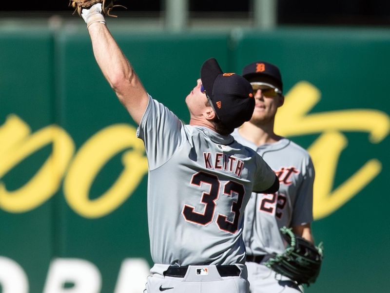 Sep 8, 2024; Oakland, California, USA; Detroit Tigers second baseman Colt Keith (33) nearly collides with Detroit Tigers center fielder Parker Meadows (22) while fielding a popup by Oakland Athletics shortstop Jacob Wilson during the ninth inning at Oakland-Alameda County Coliseum. Mandatory Credit: D. Ross Cameron-Imagn Images