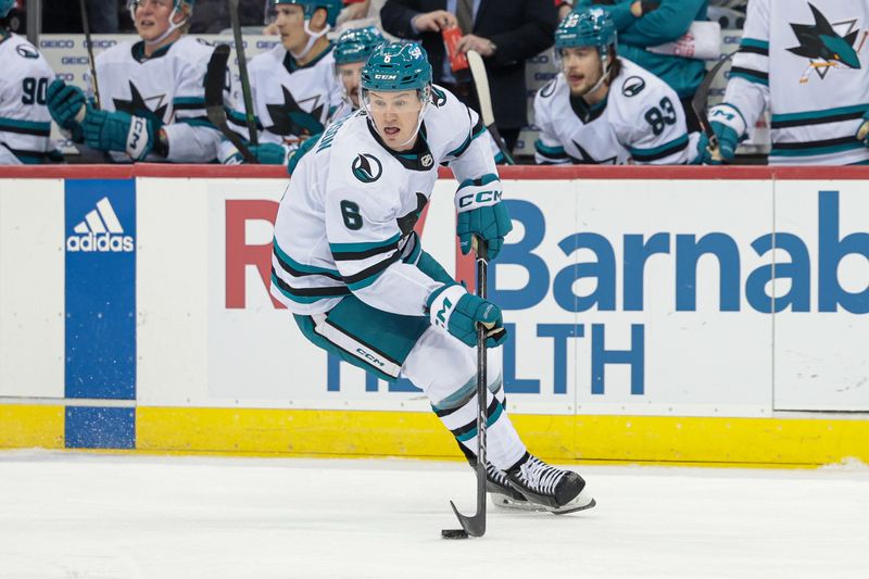 Dec 1, 2023; Newark, New Jersey, USA; San Jose Sharks defenseman Ty Emberson (6) skates with the puck during the first period against the New Jersey Devils at Prudential Center. Mandatory Credit: Vincent Carchietta-USA TODAY Sports