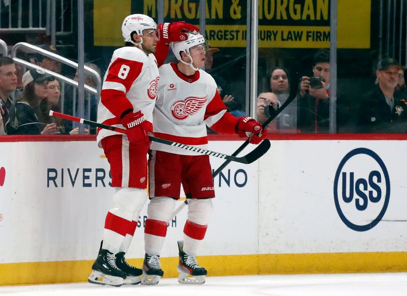 Apr 11, 2024; Pittsburgh, Pennsylvania, USA; Detroit Red Wings defenseman Ben Chiarot (8) congratulates left wing Lucas Raymond (right) on his goal against the Pittsburgh Penguins during the first period at PPG Paints Arena. Mandatory Credit: Charles LeClaire-USA TODAY Sports