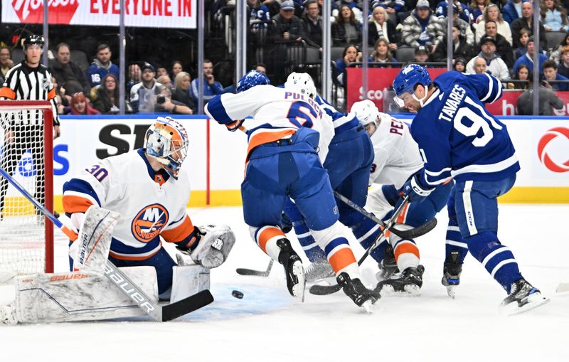 Feb 5, 2024; Toronto, Ontario, CAN; (Editors Notes: Caption Correction)  New York Islanders goalie Ilya Sorokin (30) makes a save as Toronto Maple Leafs forward John Tavares (91) looks for a rebound in the first period at Scotiabank Arena. Mandatory Credit: Dan Hamilton-USA TODAY Sports