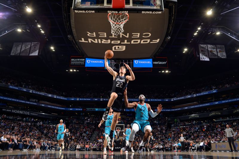 PHOENIX, AZ - MARCH 16: Franz Wagner #22 of the Orlando Magic drives to the basket during the game against the Phoenix Suns on March 16, 2022 at Footprint Center in Phoenix, Arizona. NOTE TO USER: User expressly acknowledges and agrees that, by downloading and or using this photograph, user is consenting to the terms and conditions of the Getty Images License Agreement. Mandatory Copyright Notice: Copyright 2022 NBAE (Photo by Barry Gossage/NBAE via Getty Images)